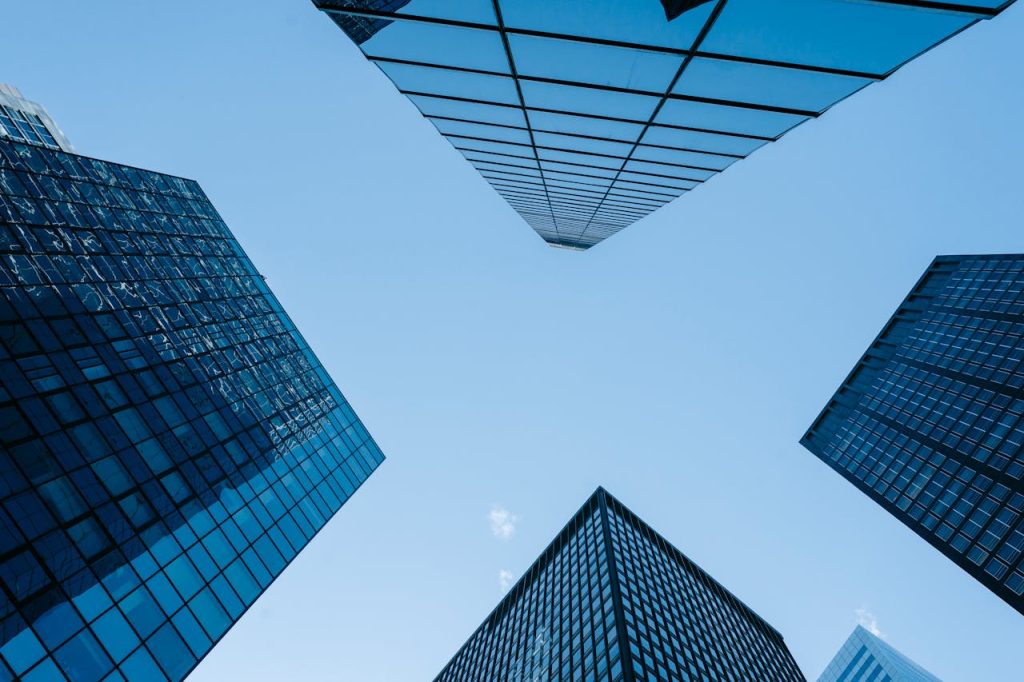 contemporary-glass-skyscrapers-under-cloudless-blue-sky-7078663 contemporary-glass-skyscrapers-under-cloudless-blue-sky-7078663